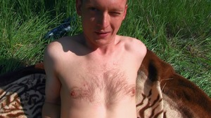 Cutesy young man seduced next to a field of flowers